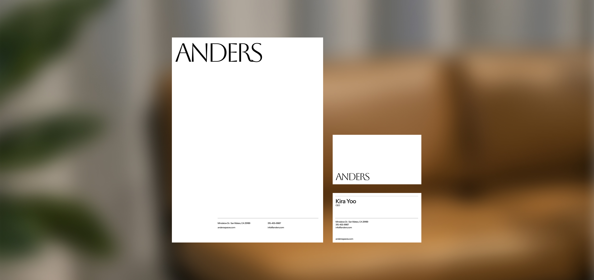 Stationery design of letterhead and business cards for the company Anders on top of a blurred photo of a house interior.